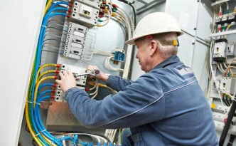 Electrician tighten the screws with spanner